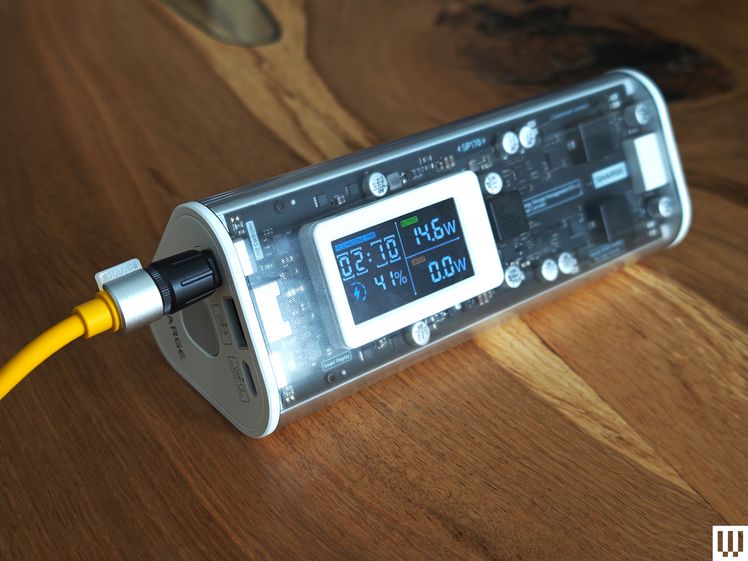 The Shargeek 170 is a long tube-shaped device with clear case that shows the internal pieces and has an external facing screen.